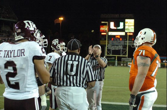University of Miami Hurricane and Texas A&M Captains meet at center field for the coin toss at the beginning of a game between the teams at the Orange...