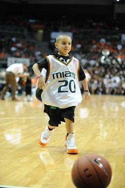 A young fan plays a game during a break between The University of Miami Hurricanes and the 2010 NCAA Final Four participant West Virginia at the...