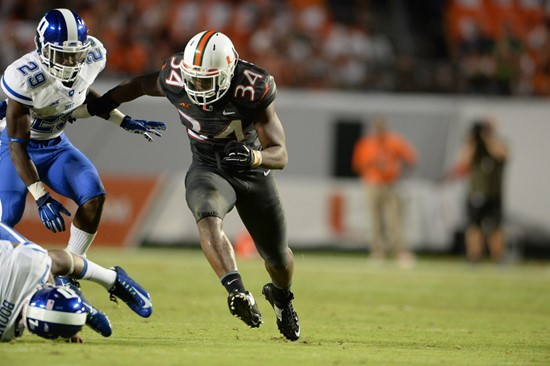 University of Miami Hurricanes head coach Al Golden leads his team on the field in a game against the Duke Blue Devils at Sun Life Stadium on...