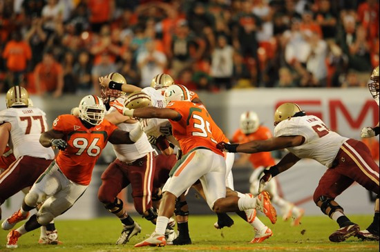 University of Miami Hurricanes defensive lineman Curtis Porter #96 and Olivier Vernon #35 pressure the quarterback for Boston College Eagles at Sun...