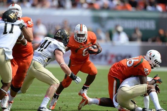University of Miami Hurricanes running back Duke Johnson #8 carried the ball 30 times for 169 yards and scored two touchdowns in a game against the...