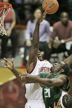 Virginia Tech's Cheick Diakite (34) blocks a shot by Miami's Dwayne Collins (21) during the first half of a basketball game in Blacksburg, Va,...