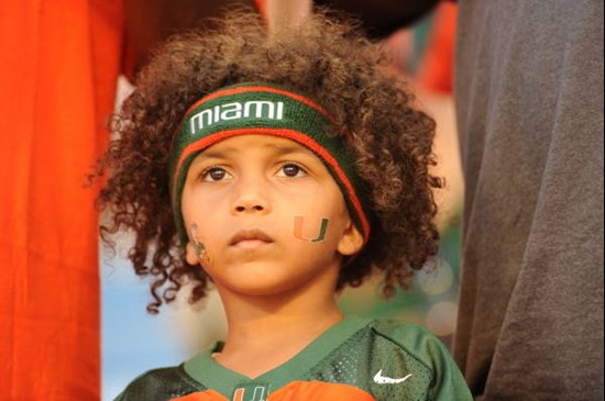 A young Hurricane fan looks on intently during a game between the University of Miami Hurricanes and the Georgia Tech Yellow Jackets at Land Shark...
