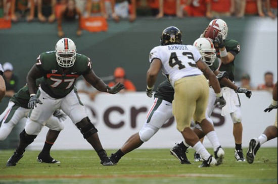 University of Miami Hurricanes offensive lineman Reggie Youngblood #77 gets set to block against the Deamon Deacons of Wake Forest at Dolphin Stadium...