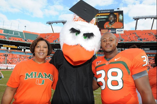 University of Miami Hurricanes running back David Thompson #38 and his mother Veronica pose for a picture with Sebastian the Ibis before a game...