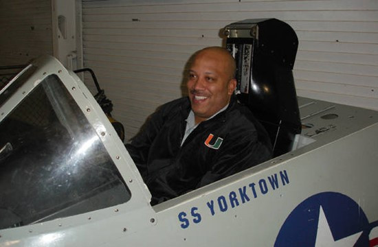 Assistant coach Jake Morton climbs into the cockpit at the Charleston Classic welcome reception aboard the USS Yorktown.