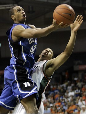 Duke's Lance Thomas (42) prepares to drop in the basket as Miami's Keaton Copeland defends in the first half of a basketball game in Coral Gables,...