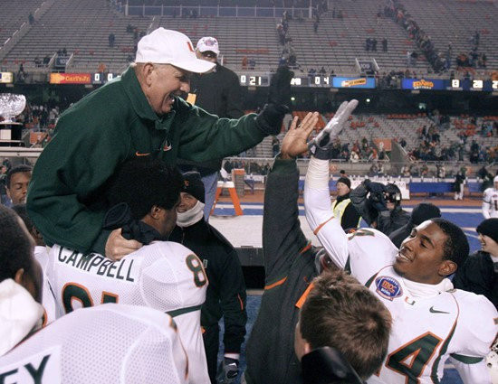 Miami coach Larry Coker high-fives defensive back Chavez Grant as he is carried by his players after Miami beat Nevada 21-20 in the MPC Computers...