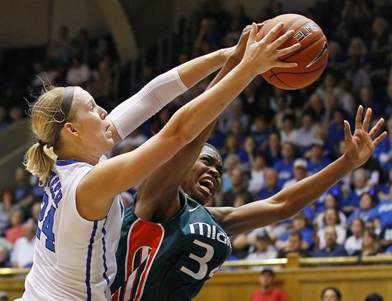 Duke's Kathleen Scheer, left, and Miami's Sylvia Bullock reach for a rebound during the first half. (AP Photo/Gerry Broome)