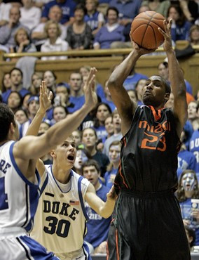 Miami's James Dews (23) shoots as Duke's Jon Scheyer (30) and David McClure, left, defend during the second half of a college basketball game in...