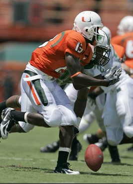 Miami running back Ryan Hill, foreground, is unable to hang on to a pass as he is covered by Marshall defensive back Aaron Johnson during the second...