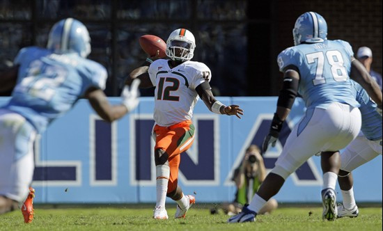Miami quarterback Jacory Harris (12) fires a pass against North Carolina's defense. (AP Photo/Gerry Broome)