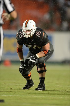 University of Miami Hurricanes offensive lineman Taylor Gadbois #76 gets set to rush in a game against the Duke Blue Devils at Sun Life Stadium on...
