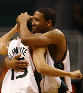 Miami guard James Dews, right, celebrates with guard Denis Clemente during the final second of basketball against Virginia Wednesday, Feb. 21, 2007 in...