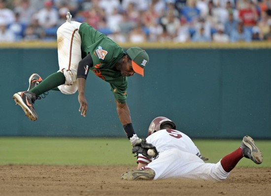 Stanford's Zach Jones, right, steals second base under the tag of Miami second baseman Jemile Weeks in the second inning of an NCAA College World...