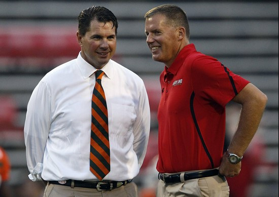 Miami head coach Al Golden, left, and Maryland head coach Randy Edsall talk before an NCAA football game in College Park, Md., Monday, Sept. 5, 2011....