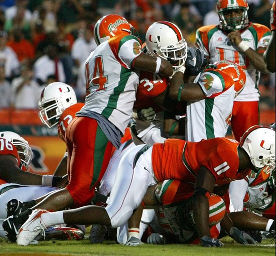 Florida A&M players are unable to stop Miami running back Charlie Jones (34) as he comes in for a touchdown during the first quarter Saturday, Sept....