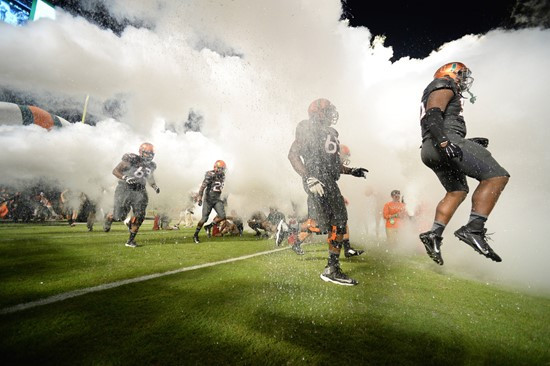 Sebastian the Ibis leads the University of Miami Hurricanes through a tunnel of smoke in a game against the Florida State Seminoles at Sun Life...