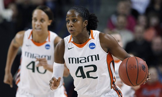 Miami's Shenise Johnson (42) brings the ball up as teammate Shawnice Wilson trails during the first half of an NCAA tournament second-round women's...