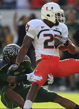 Brandon McGee is dragged down by South Florida wide receiver Andre Davis after making an interception. (AP Photo/Chris O'Meara)
