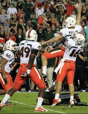 Jake Wieclaw celebrates with teammates, including Chris Ivory, Dyron Dye and Spencer Whipple after kicking the game-winning 36-yard field goal during...