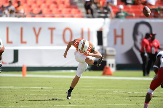 University of Miami Hurricanes punter Justin Vogel #16 plays in a game against the Cincinnati Bearcats at Sun Life Stadium on October 11, 2014.  Photo...