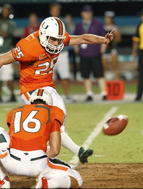 Miami kicker Matt Bosher (25) kicks a field goal as quarterback Spencer Whipple holds during the first half of an NCAA college football game against...