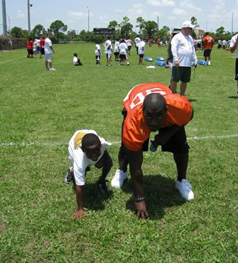 Steven Wesley teaches a youngster defensive line technique at the Ezell Hester Community Center