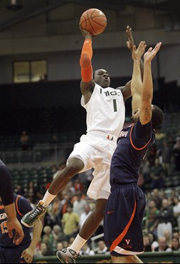 Miami's Durand Scott, (1) puts a shot up over Virginia's Calvin Baker (4), during an NCAA college basketball game on Tuesday, Feb. 23, 2010 in Coral...