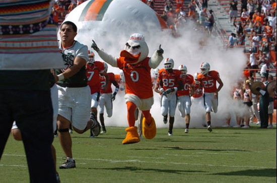 University of Miami mascot Sebastian the Ibis leads the Hurricanes through a tunnel of smoke at the beginning of a game against the North Carolina...