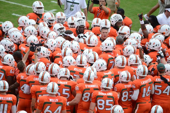 University of Miami Hurricane players meet at the 50 yard line in a sign of unity before a game against the #12 ranked University of Florida Gators at...