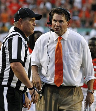 Miami head coach Al Golden talks with an official in the fourth quarter of an NCAA college football game against Kansas State Saturday, Sept. 24,...