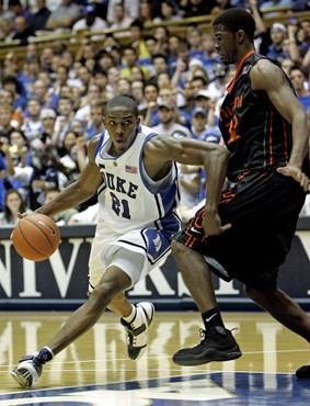 Duke's DeMarcus Nelson (21) drives past Miami's Brian Asbury during the first half of a college basketball game in Durham, N.C., Saturday, Feb. 2,...
