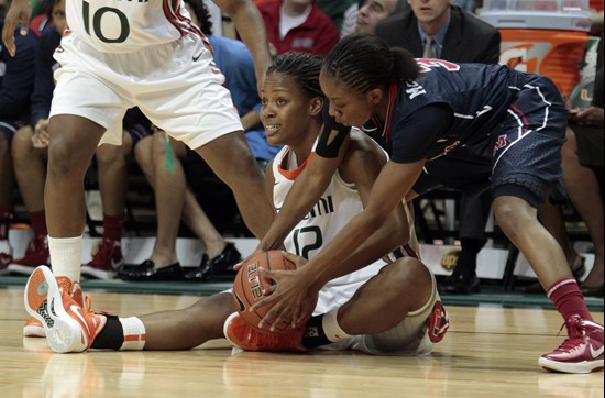 Ole Miss' Valencia McFarland (3) battles Miami's Krystal Saunders (12) for control of a loose ball in the first half. (AP Photo/Alan Diaz)