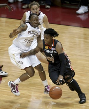 Miami's Riquana Williams, right, drives past Florida State's Alysha Harvin during the first half of an NCAA college basketball game Thursday, Feb. 25,...