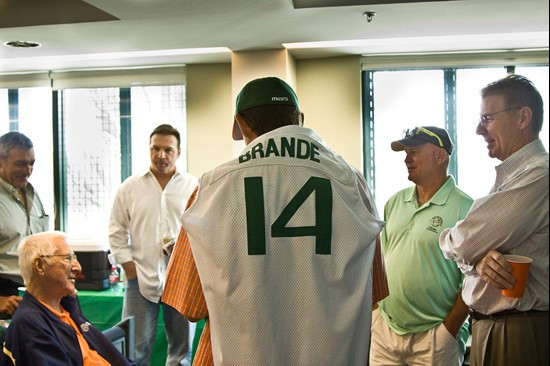 Luis listens on as teammates share stories during a luncheon held at Mark Light Field.