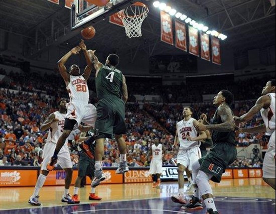 Miami's Trey McKinney-Jones (4) blocks a shot by Clemson's Jordan Roper (20) in the final seconds of an NCAA college basketball game, Sunday, Feb. 17,...