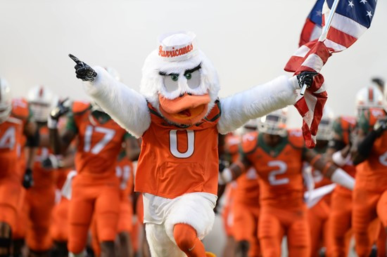 Sebastian the Ibis leads the University of Miami Hurricanes onto the field through a tunnel of smoke in a game against the Florida A&M Rattlers at Sun...