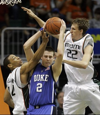 Duke's Josh McRoberts (2) recovers a rebound over Miami's Keaton Copeland, left, and Fabio Naas (22) in the first half of a basketball game in Coral...