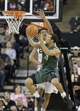 Miami's Trey McKinney Jones (4) shoots over Wake Forest's Devin Thomas (2) during the first half of an NCAA college basketball game in Winston-Salem,...