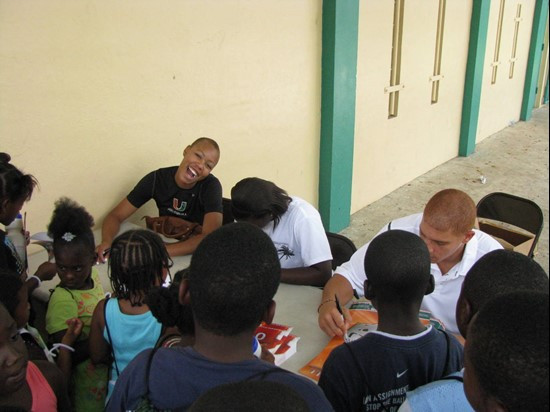 Christine Williamson enjoys a smile as Charmaine Clark and Jimmy Graham sign autographs