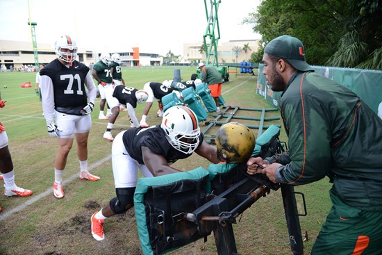 Defensive linemen hit the sleds with GA Kareem Brown