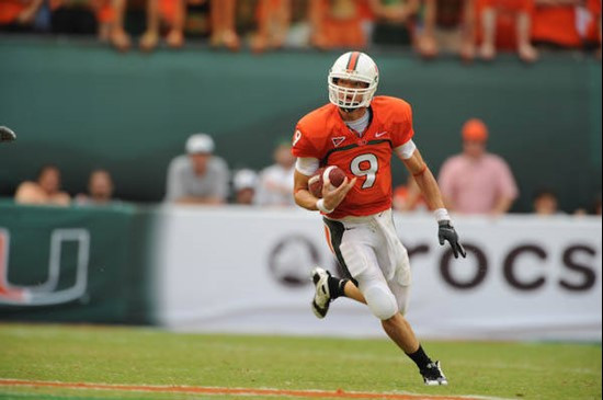 University of Miami Hurricanes quarterback Robert Marve #9 carries the ball for a first down in a game against the University of Central Florida...