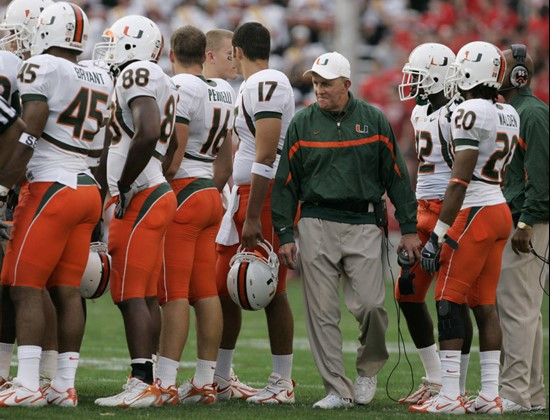 Miami head coach Larry Coker, fourth from right, walks past members of his team during the first half of their football game against Maryland,...