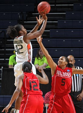 Miami guard Shenise Johnson (42) shoots over Gardner-Webb guards Dominique Hudson (12) and Brianna Dillard (5) during the first round of the NCAA...