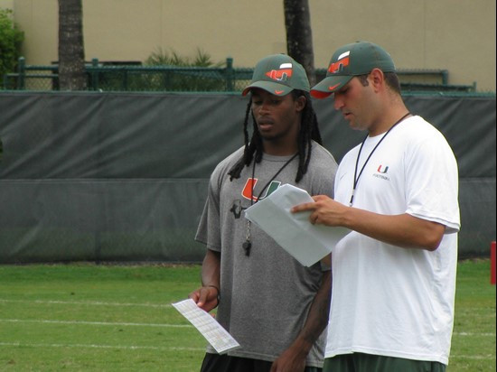 Travis Benjamin talks to another coach during an offensive team drill on Wednesday.