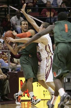 Miami's Trey McKinney Jones looks for help from his teammates as he backed up by the defense of Florida State's Luke Loucks  in the second half of an...