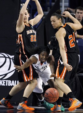 Miami's Jessica Capers, center, eyes a loose ball between Idaho State's Ashleigh Vella (22) and Cydney Horton (24) in the first half of an NCAA...