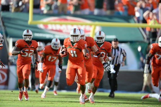 Defensive lineman David Gilbert #11 and The University of Miami Hurricanes plays in a game against the Virginia Cavaliers at Sun Life Stadium on...
