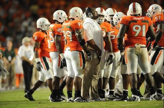 University of Miami Hurricanes defensive line coach Clint Hurtt discusses a call with his players in a game against the Georgia Tech Yellow Jackets at...